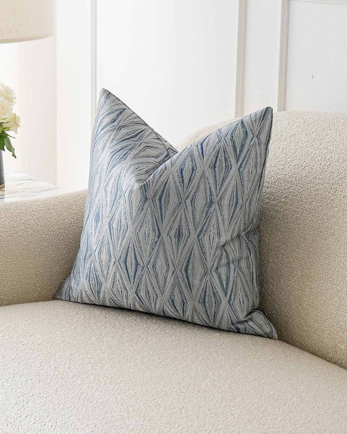 Titus Matisse cushion in silver and blue, shown in a lifestyle front view as image 2