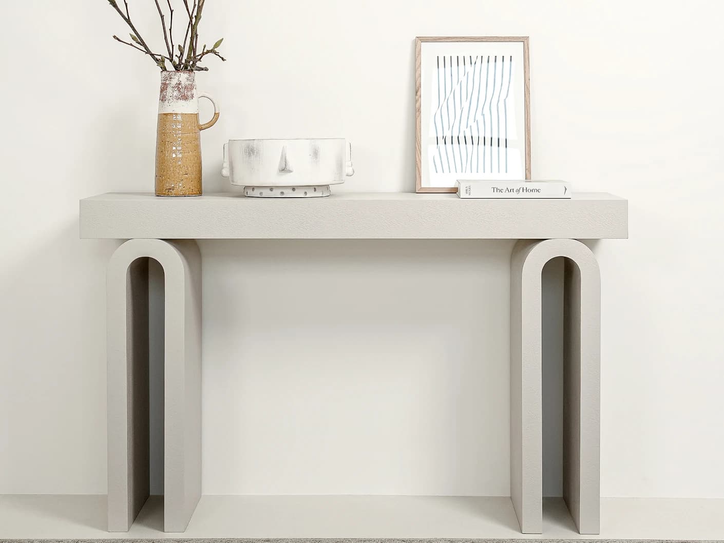 Trento console table in soft ivory and stone, shown in a lifestyle front view as image 2