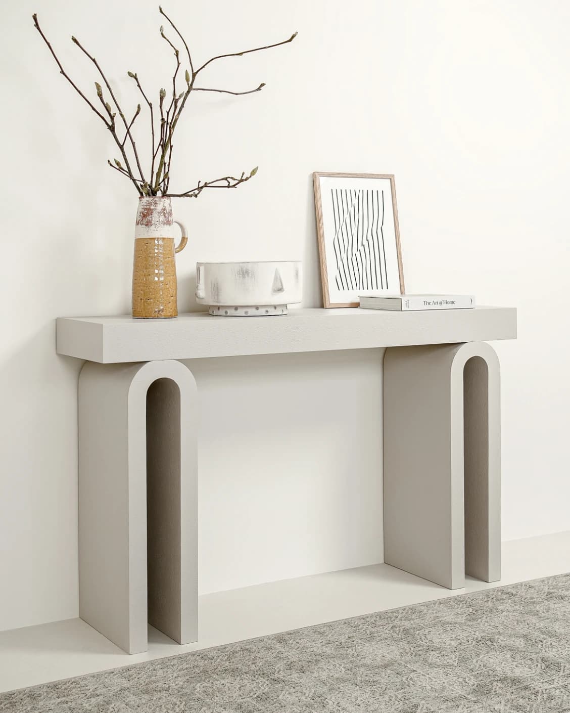 Trento console table in soft ivory and stone, shown in a lifestyle left view as image 2