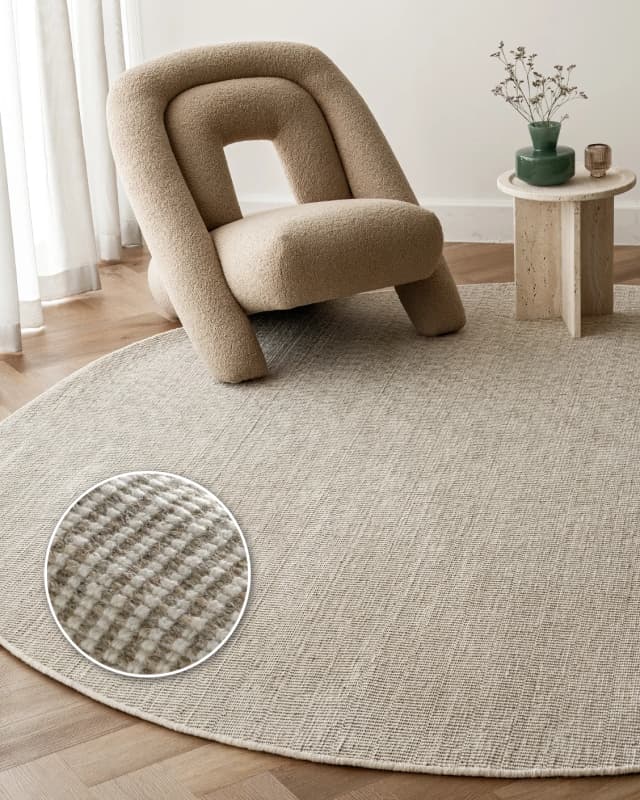 Treva Stone Round carpet in beige and taupe, shown in a lifestyle front view