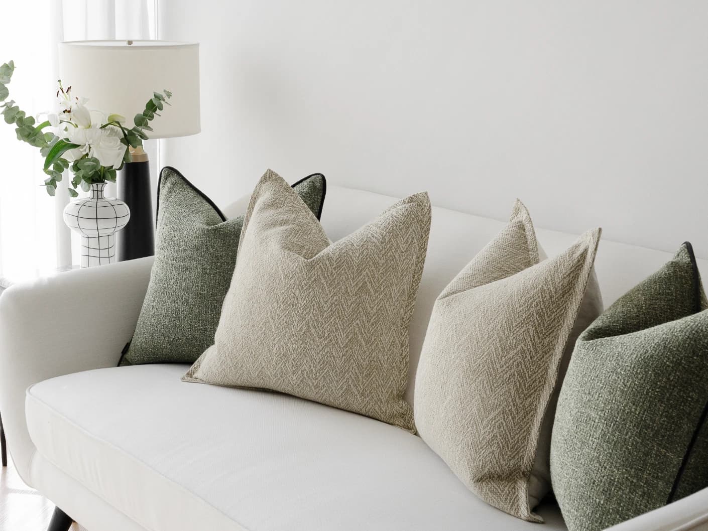 Trish Bundle bundle cushions in beige and green, shown in a lifestyle front view