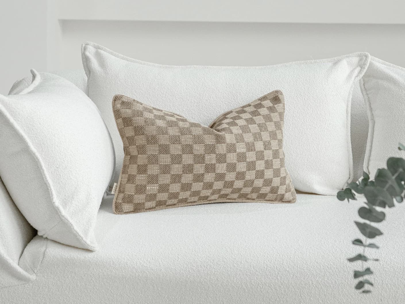 Troi Klimt II single cushions in taupe and beige, shown in a lifestyle front view