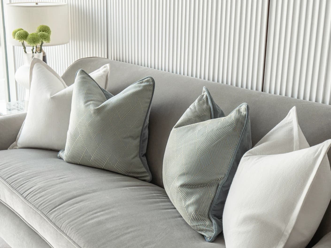 Tyler Bundle bundle cushions in white and blue, shown in a lifestyle front view