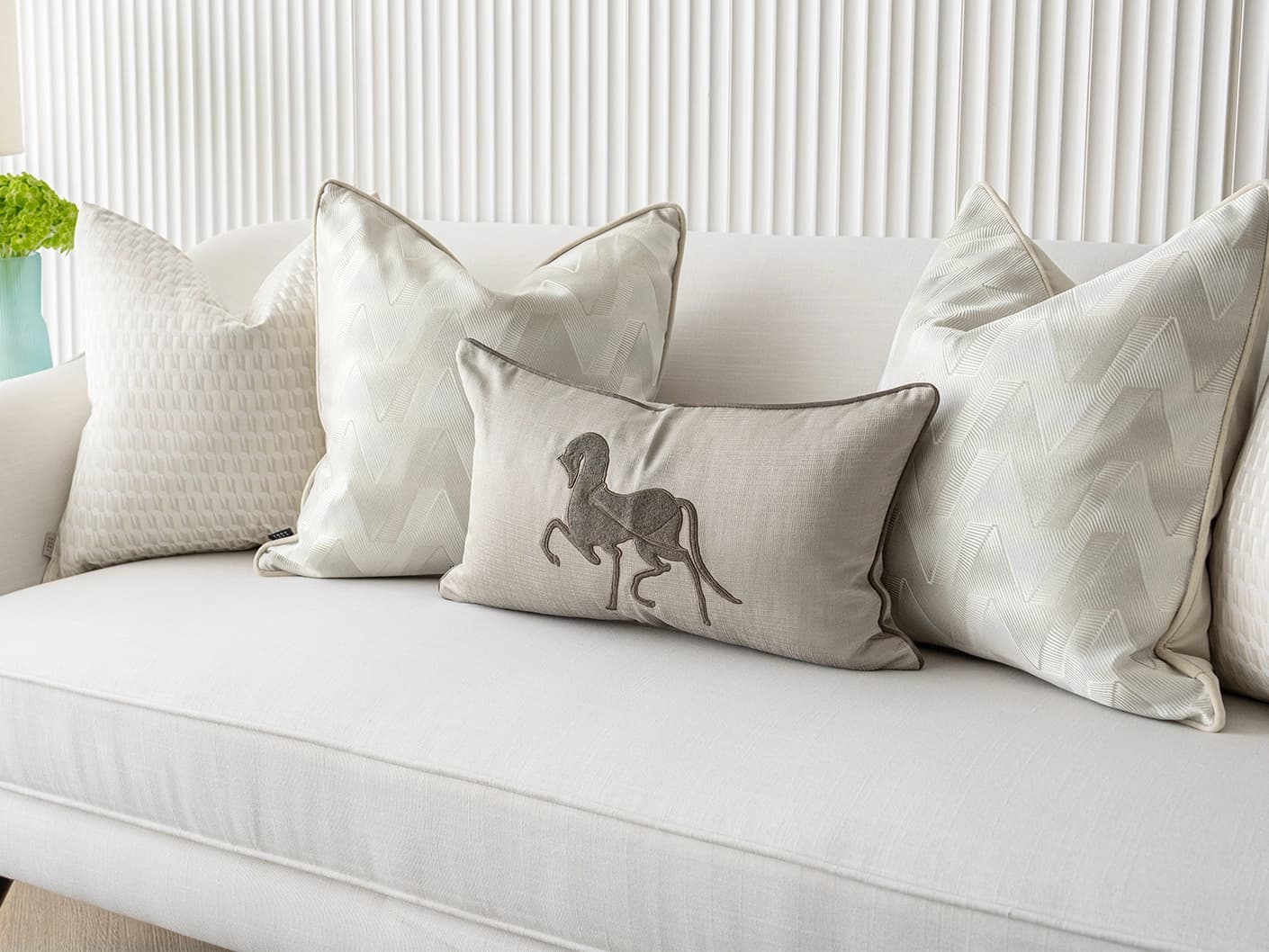 Vaani Bundle bundle cushions in brown, beige, silver and white, shown in a lifestyle front view