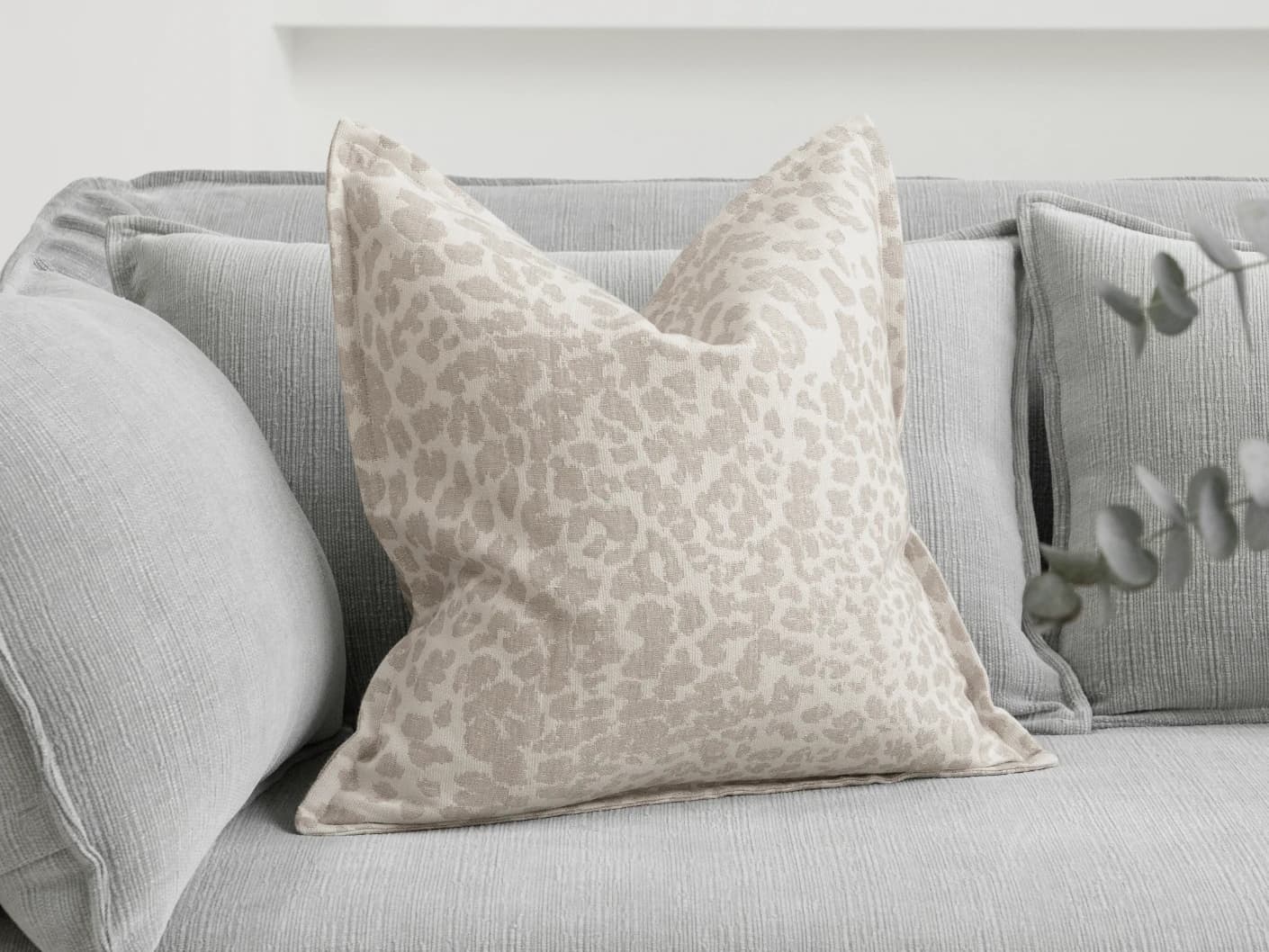 Val Klimt single cushions in beige and ivory, shown in a lifestyle front view