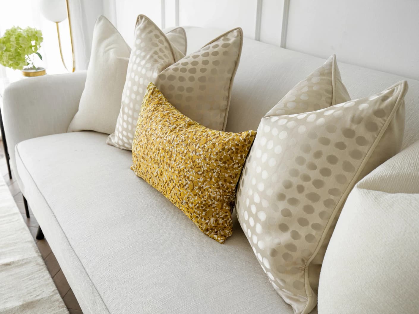 Valentina Bundle bundle cushions in white, gold, yellow and beige, shown in a lifestyle front view
