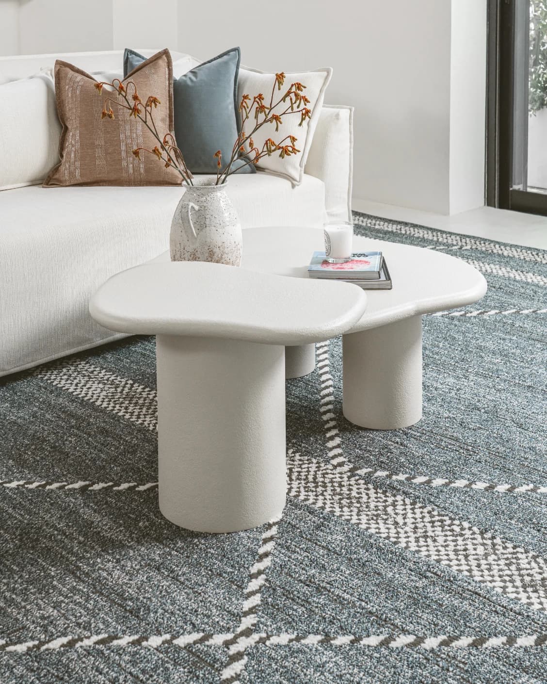 Verona side table in soft ivory and stone, shown in a lifestyle left view as image 2