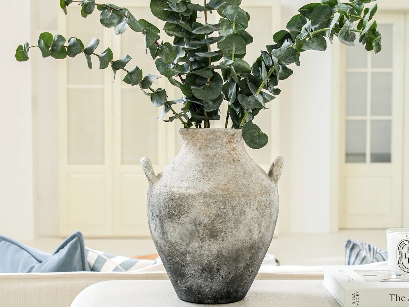 Vess Terra vases in stone and grey, shown in a lifestyle front view