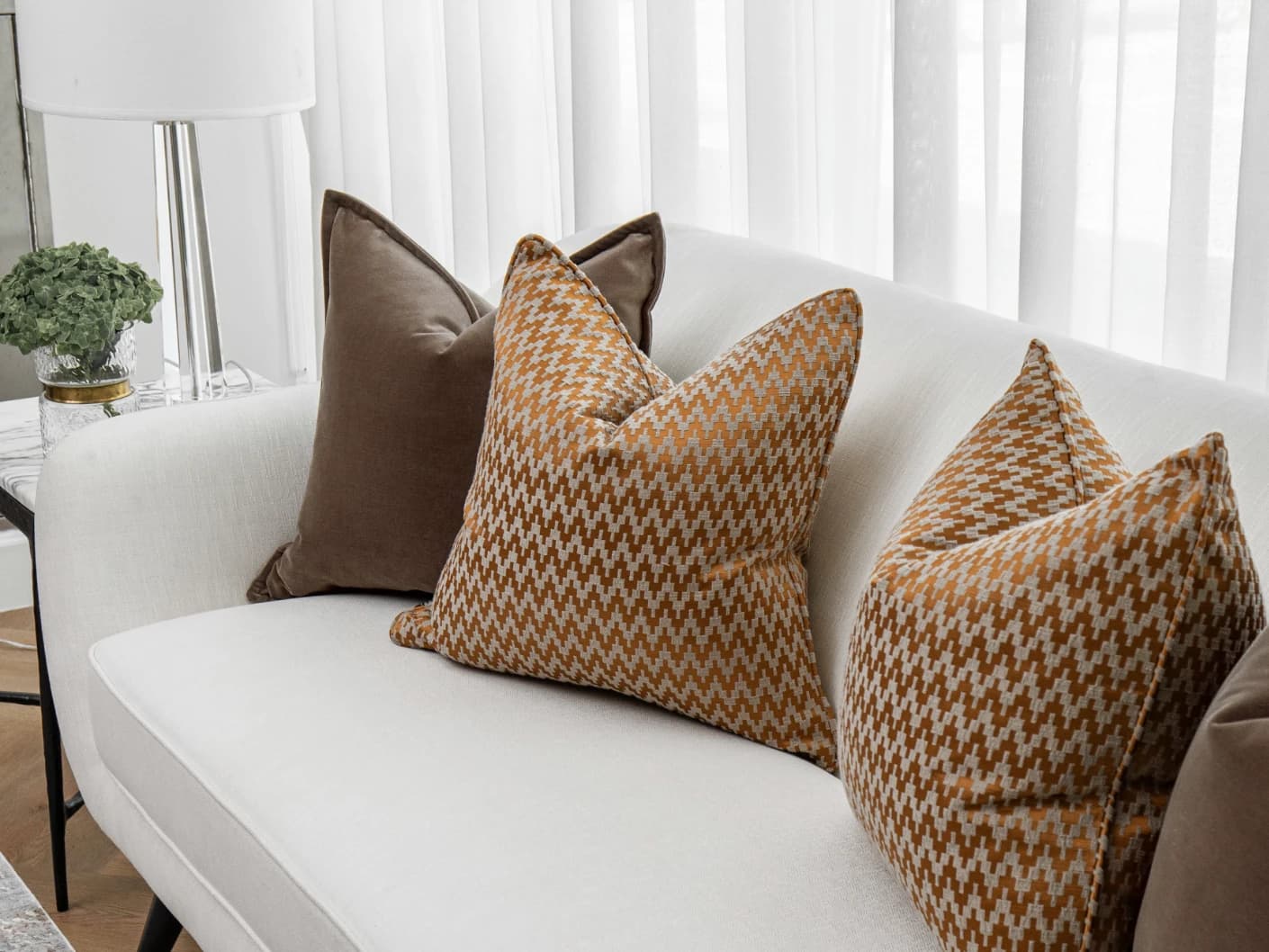 Vicente Bundle bundle cushions in brown and orange, shown in a lifestyle front view