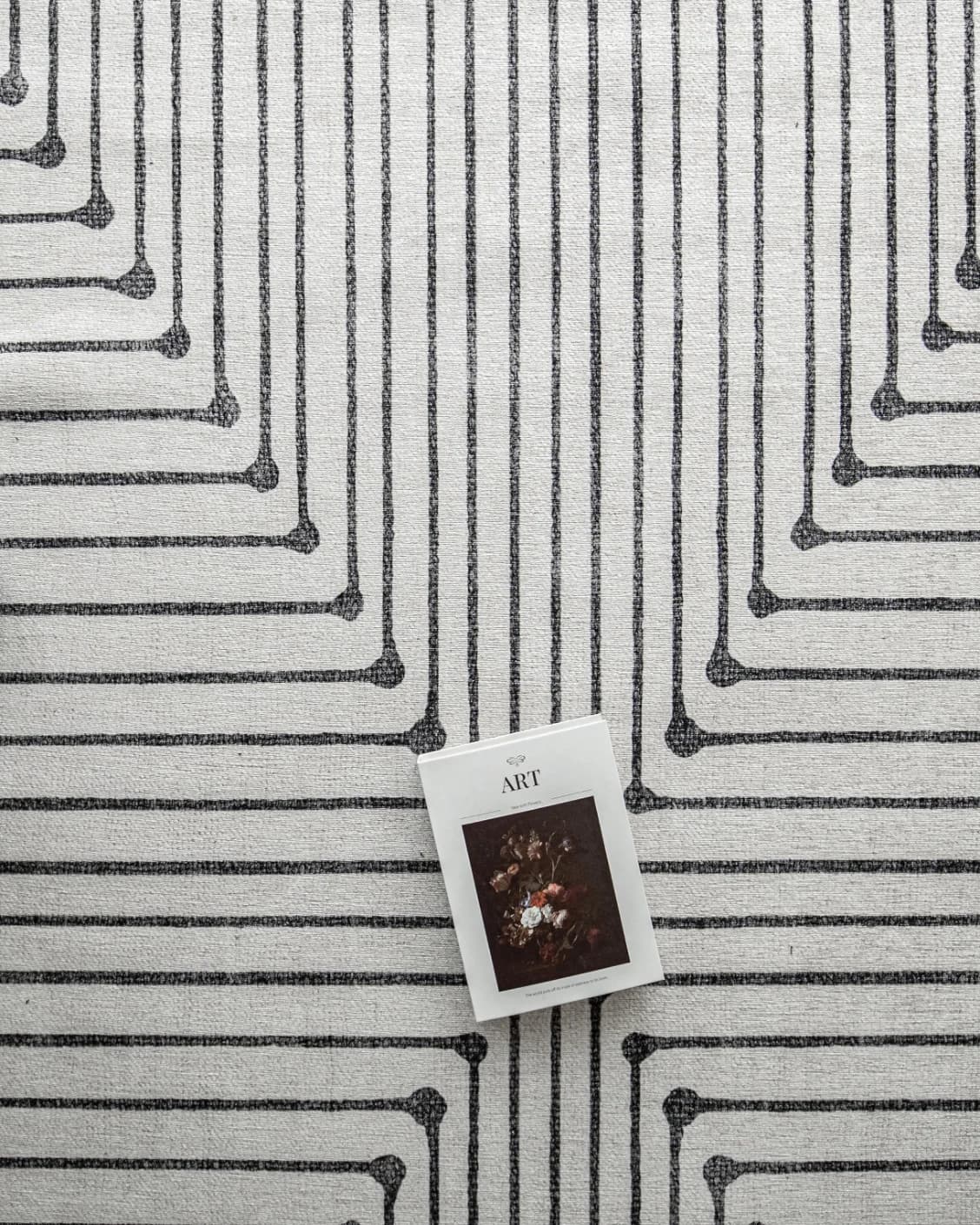 Vince Bianca carpet in black and white, shown in a lifestyle top view as image 8