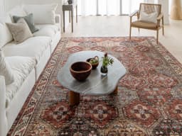 Vince Rosso carpet in rust and multicolour, shown in a lifestyle front view