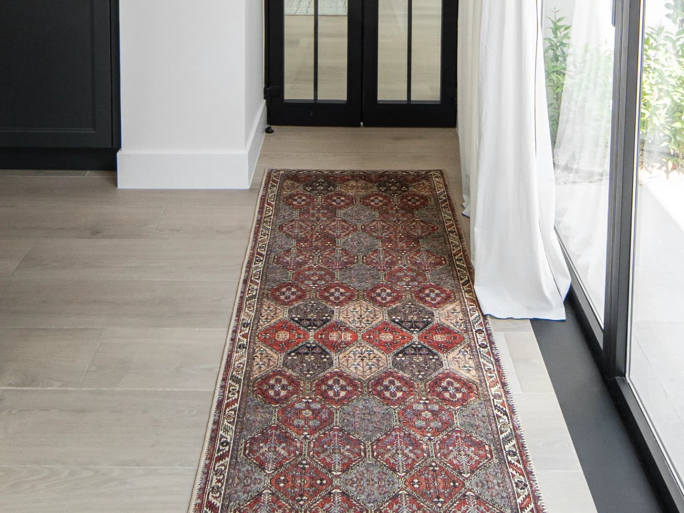Vince Rosso Runners carpet in rust and multicolour, shown in a lifestyle front view