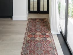 Vince Rosso Runners carpet in rust and multicolour, shown in a lifestyle front view