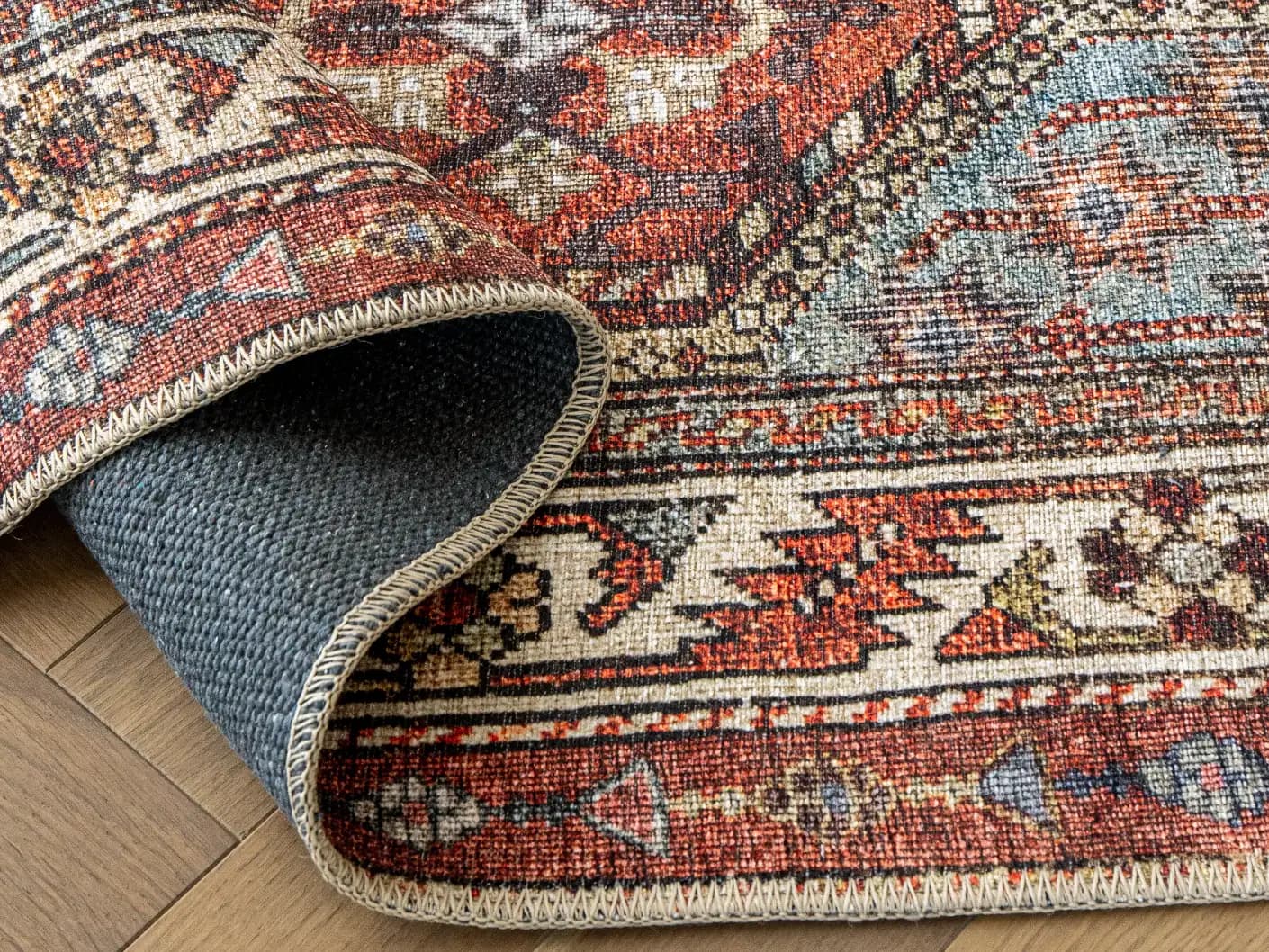 Vince Rosso carpets in rust and multicolour, shown in a product close-up view