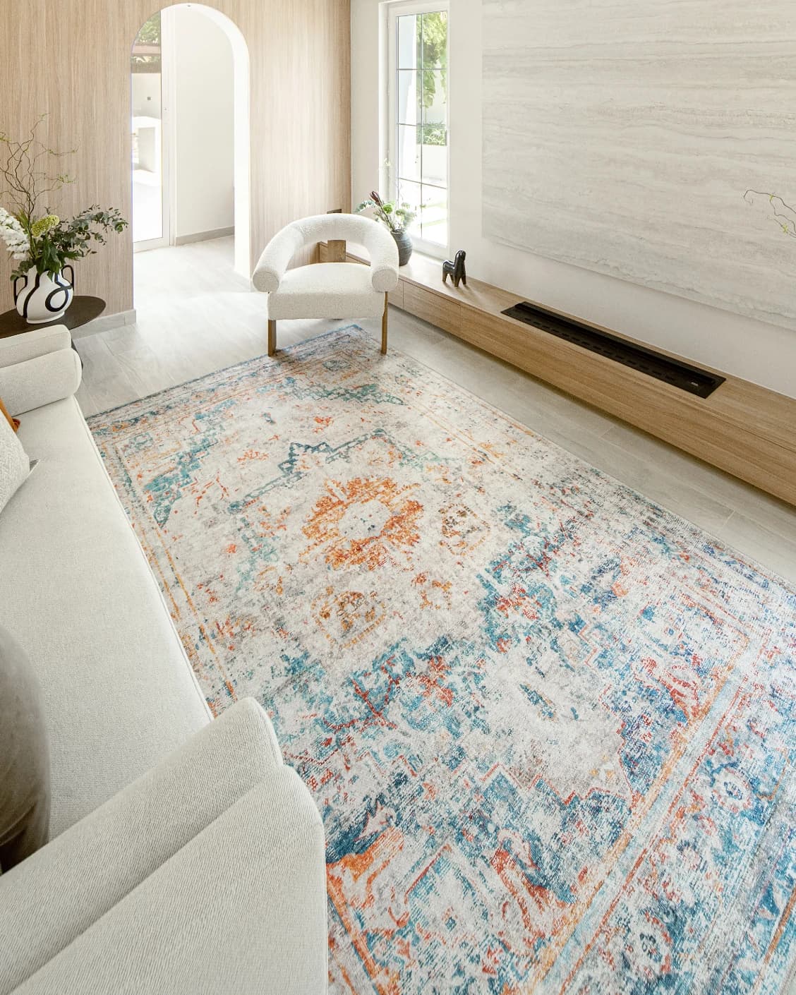 Vince Tangelo carpet in beige, blue, orange and multicolour, shown in a lifestyle left view as image 6