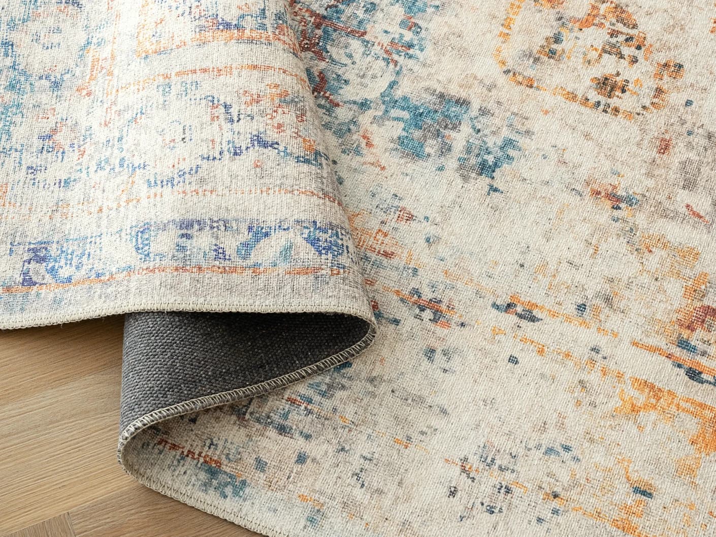 Vince Tangelo carpets in tangelo, beige, blue, orange and multicolour, shown in a product close-up view