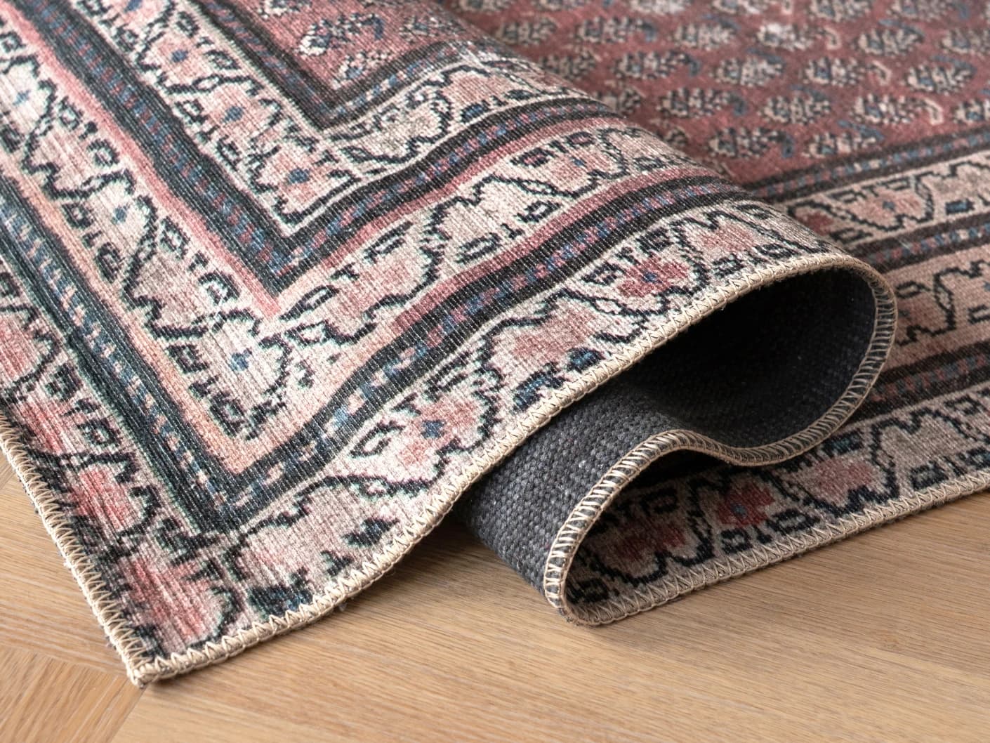 Vincent Coral carpets in coral, red and multicolour, shown in a product close-up view