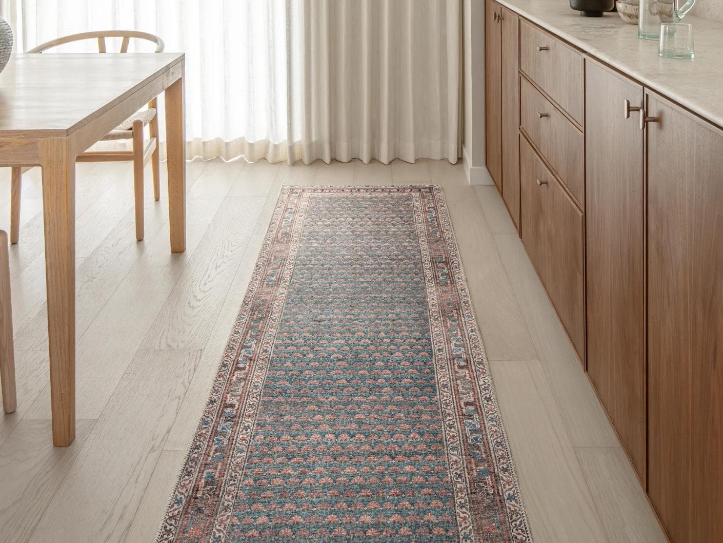 Vincent Denim carpets in blue, rust and multicolour, shown in a lifestyle front view as image 1