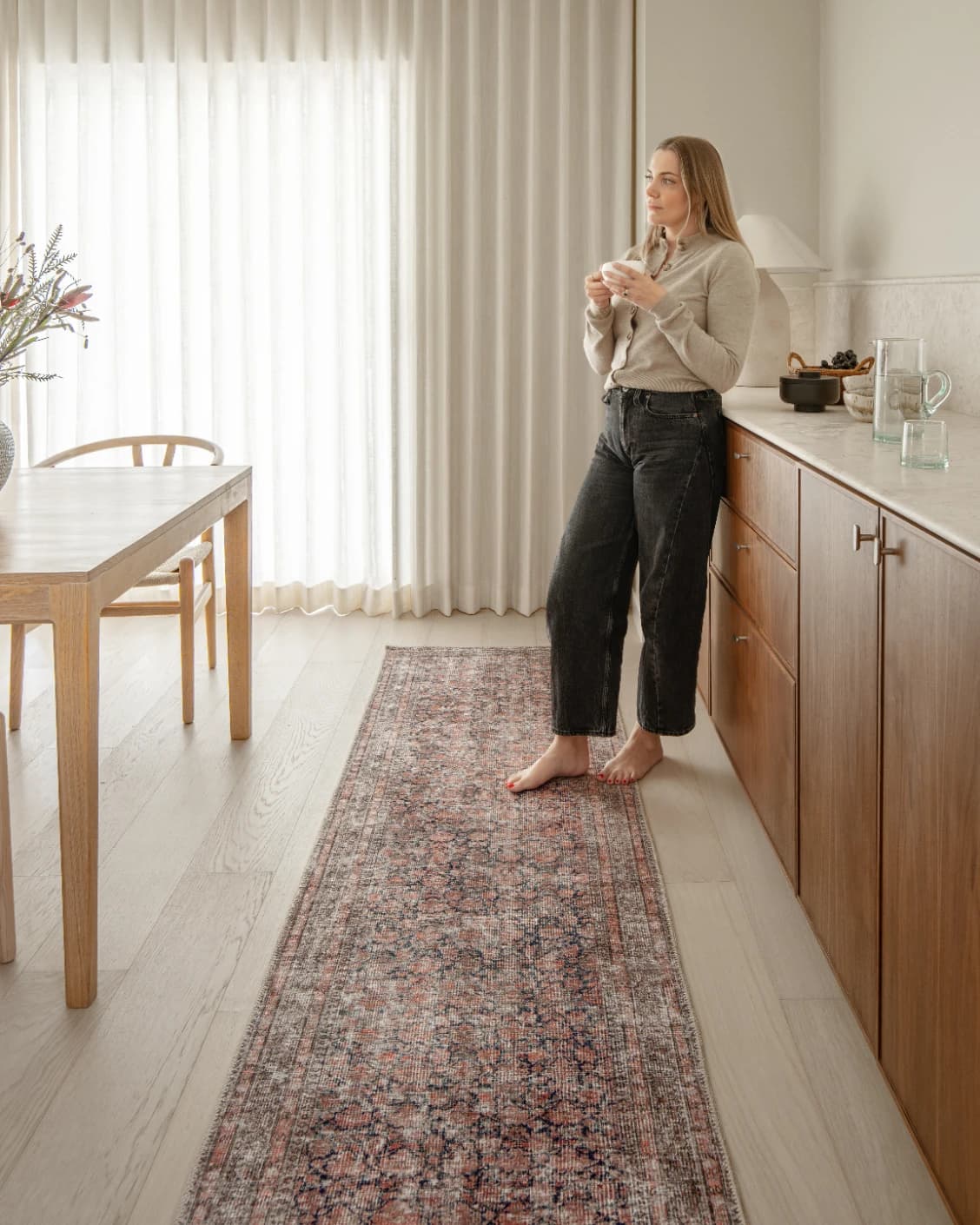 Vincent Terracotta carpet in rust and multicolour, shown in a lifestyle front view as video image
