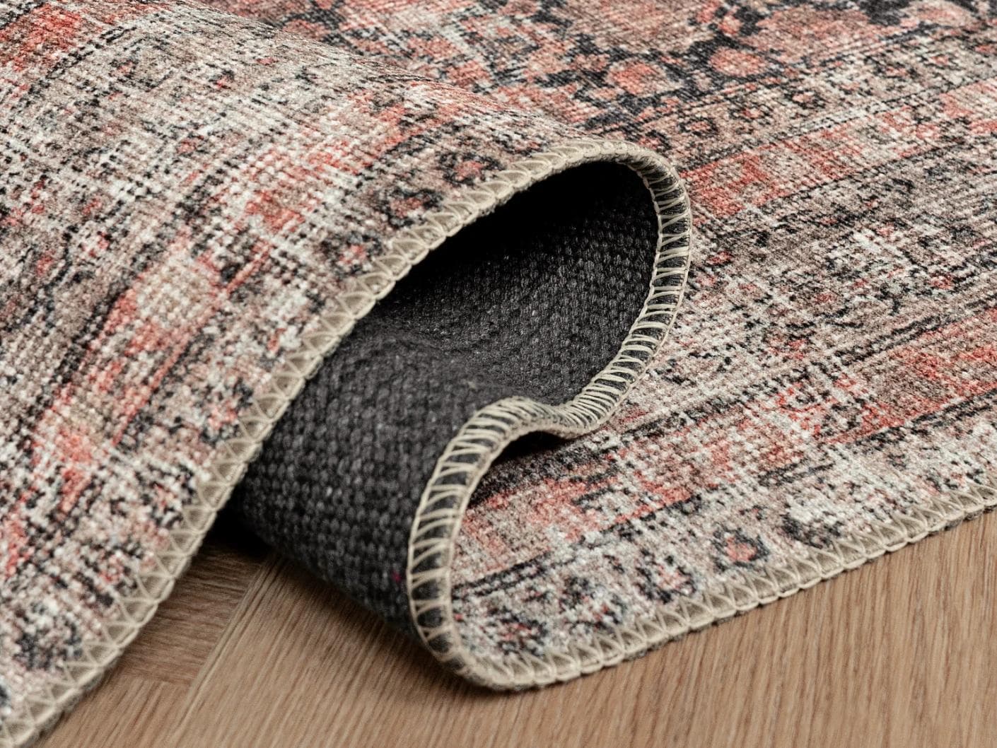 Vincent Terracotta carpets in rust and multicolour, shown in a product close-up as image 1