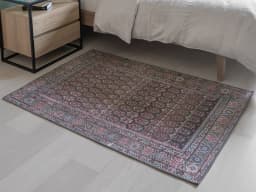 Vincent Umber carpet in red, blue and multicolour, shown in a lifestyle front view