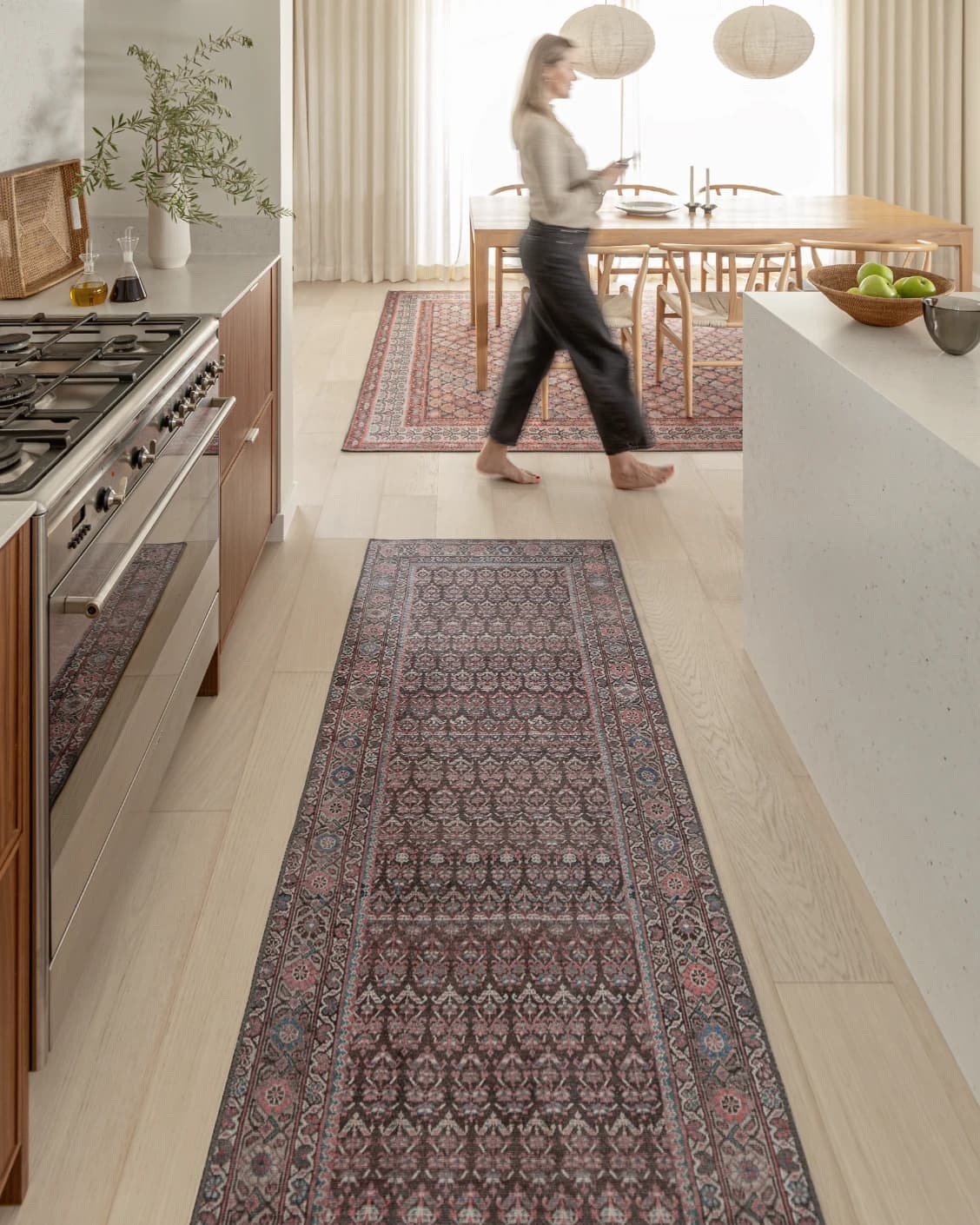Vincent Umber carpet in red, blue and multicolour, shown in a lifestyle front view as video image