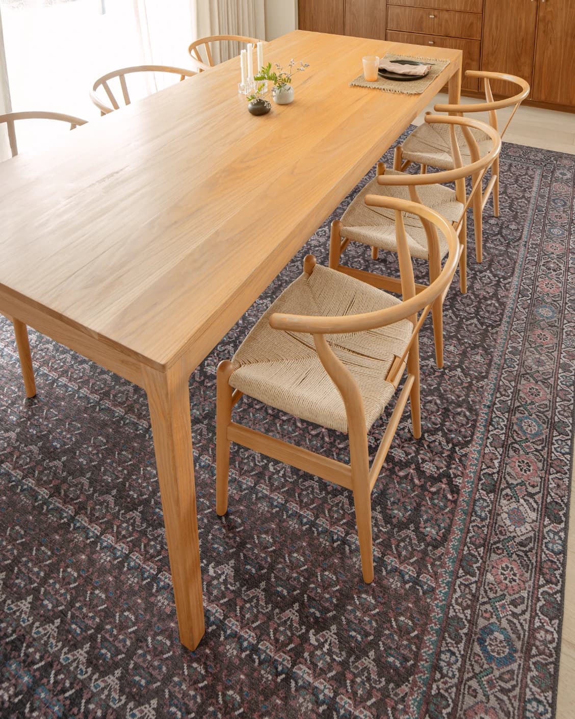 Vincent Umber carpet in red, blue and multicolour, shown in a lifestyle top view as video image