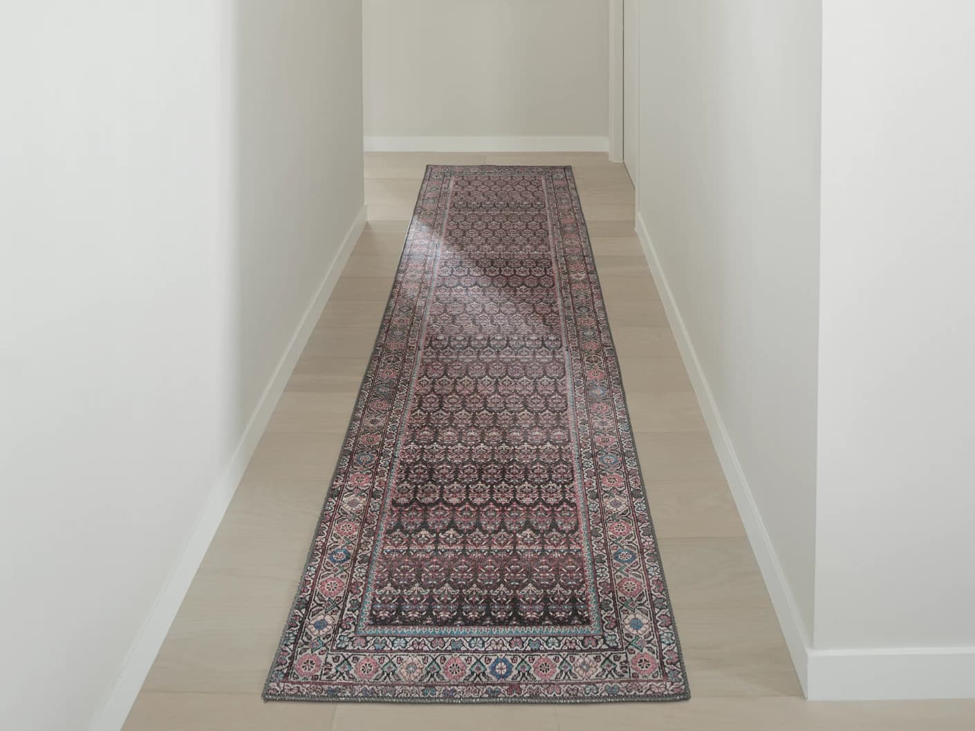 Vincent Umber Runners carpet in red, blue and multicolour, shown in a lifestyle front view