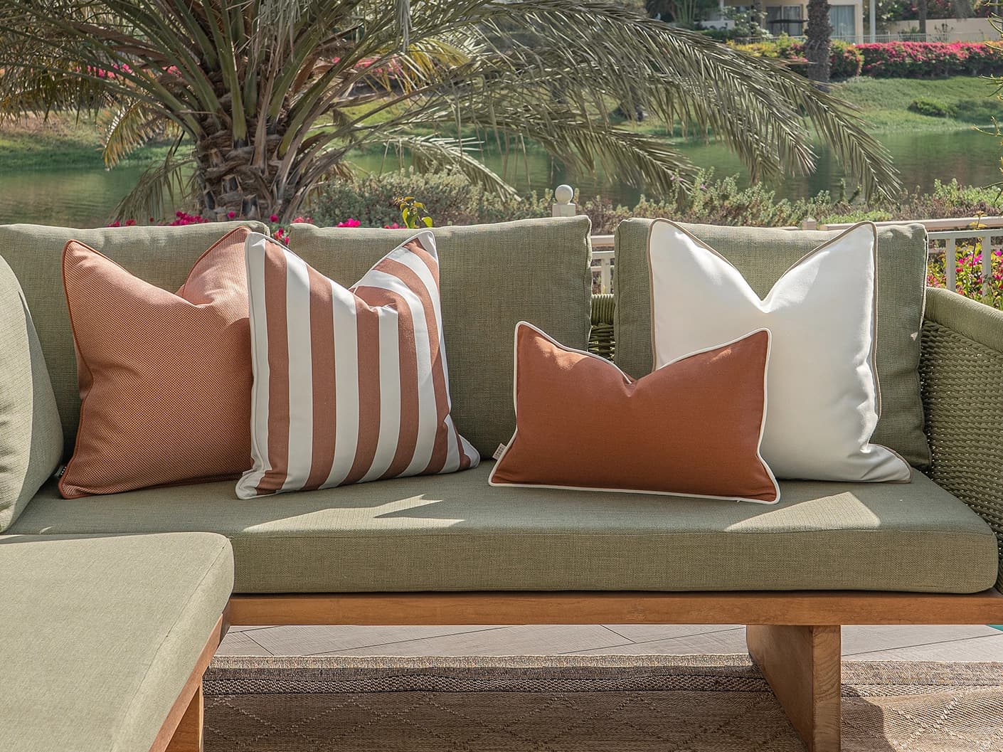 Vion Bundle bundle cushions in rust and ivory, shown in a lifestyle front view