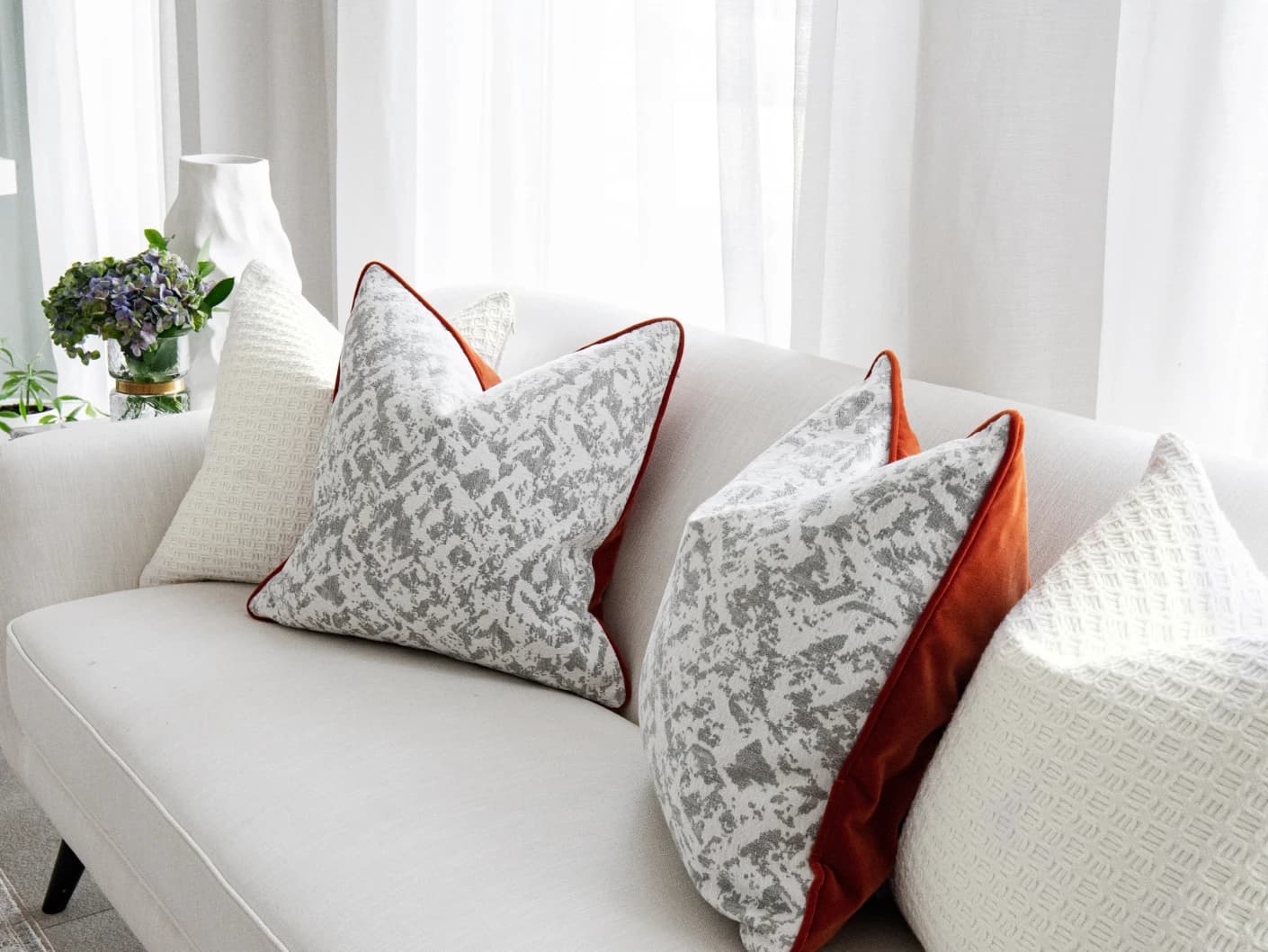 Vivien Bundle bundle cushions in white and silver, shown in a lifestyle front view