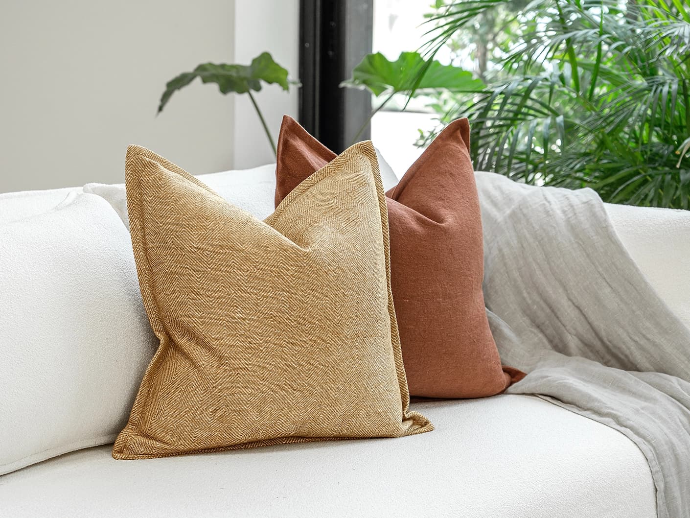 Vixi Bundle bundle cushions in dune, brown and rust, shown in a lifestyle front view
