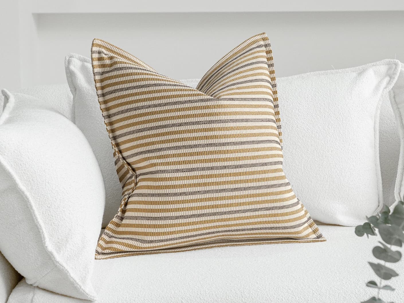 Wren Laurent single cushions in ivory and multicolour, shown in a lifestyle front view