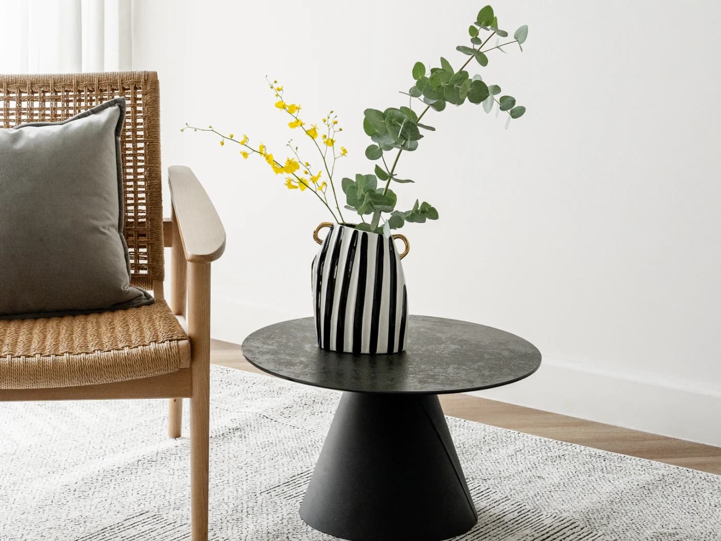 Yara Arneson vases in gold, black and white, shown in a lifestyle front view