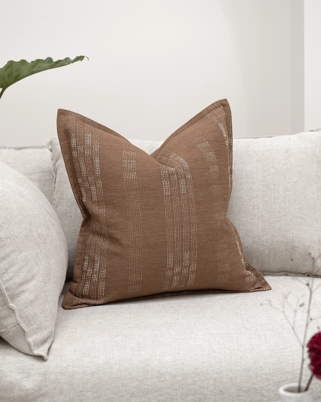 Yon Brick cushion in brown, shown in a lifestyle front view as image 2