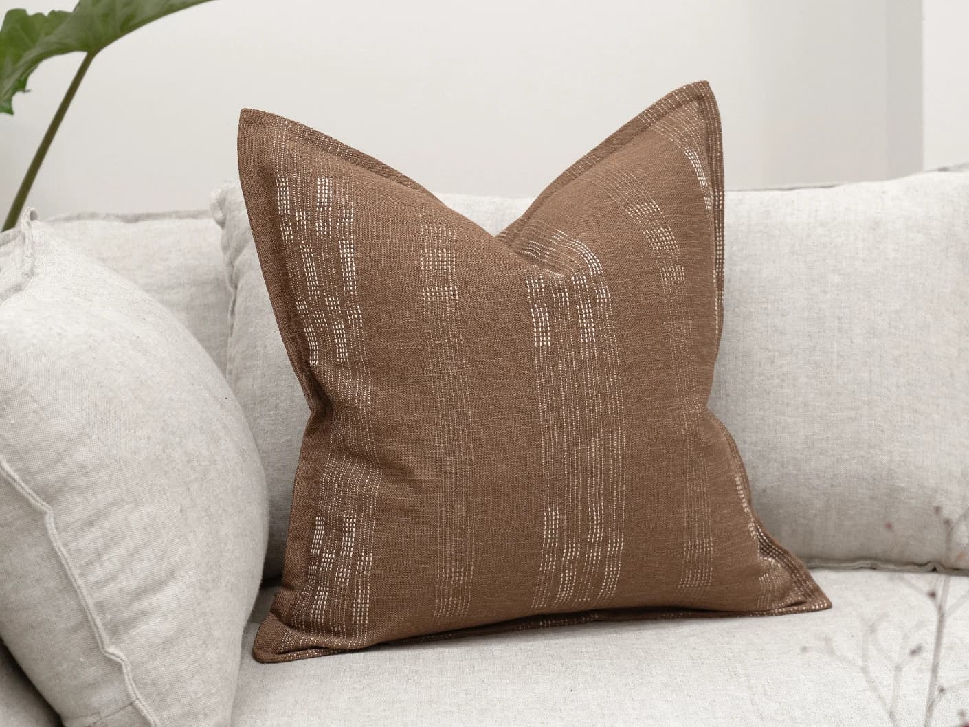 Yon Brick single cushions in brown, shown in a lifestyle front view