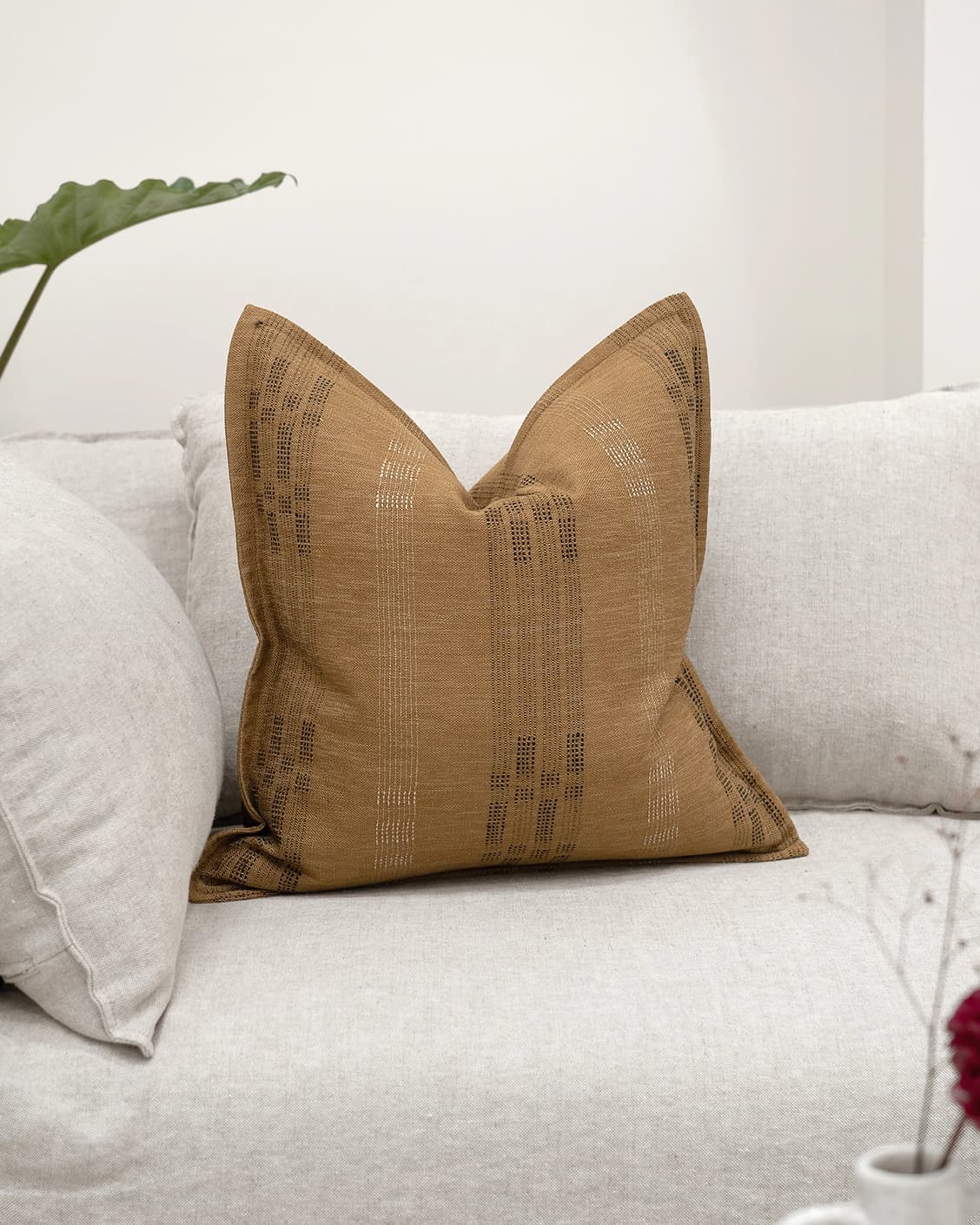 Yon Ochre cushion in ochre brown, shown in a lifestyle front view as image 2