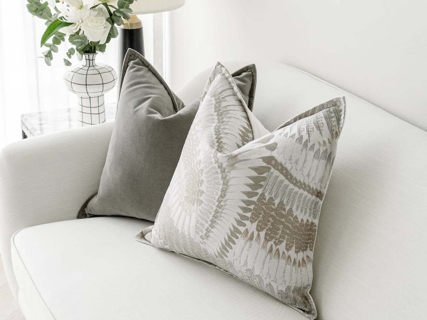 Yumi Bundle bundle cushions in grey and brown, shown in a lifestyle front view