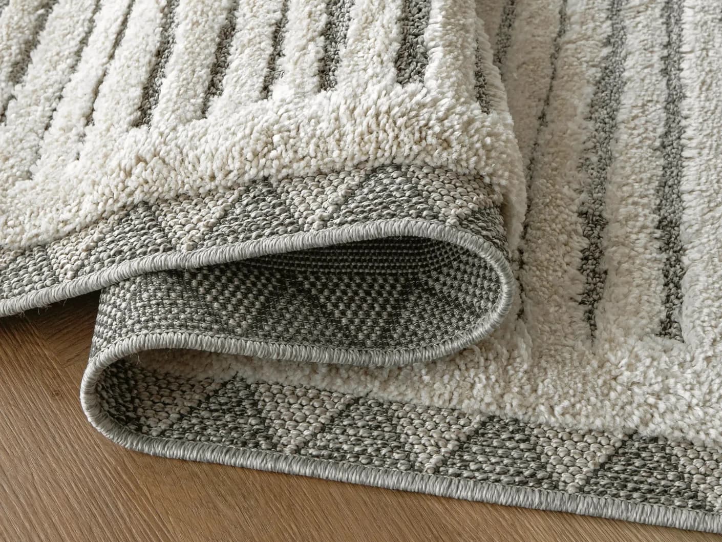 Zahra Alba carpets in ivory and grey, shown in a product close-up view