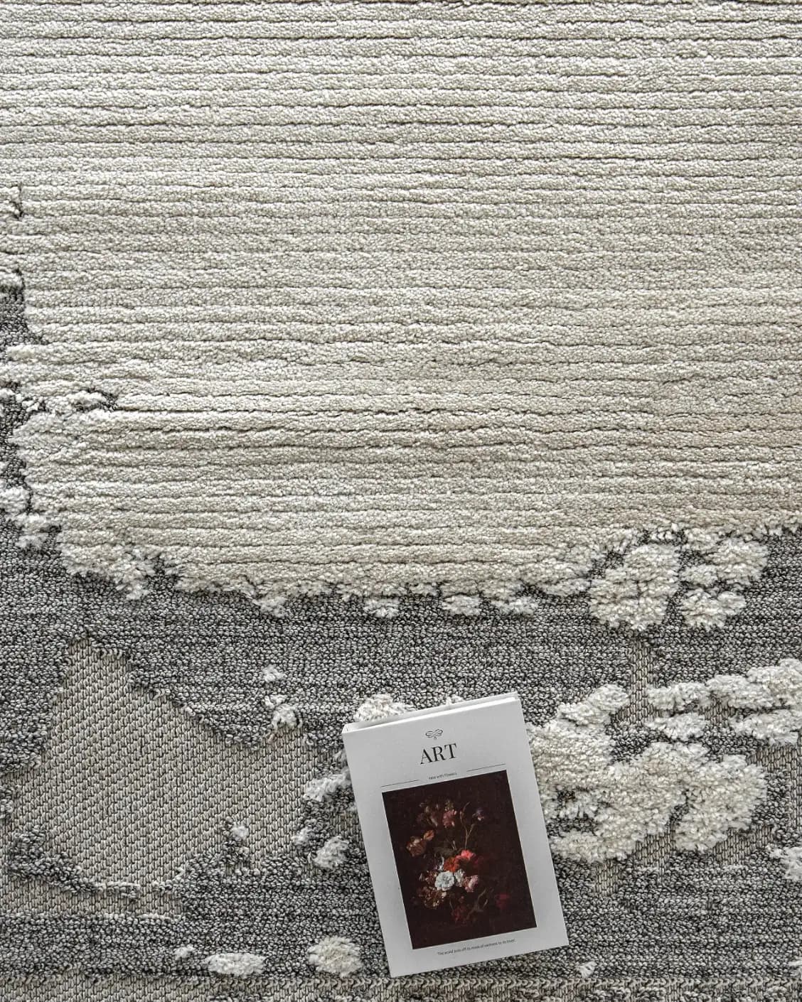 Zahra Bianca carpet in grey and ivory, shown in a lifestyle top view as image 7