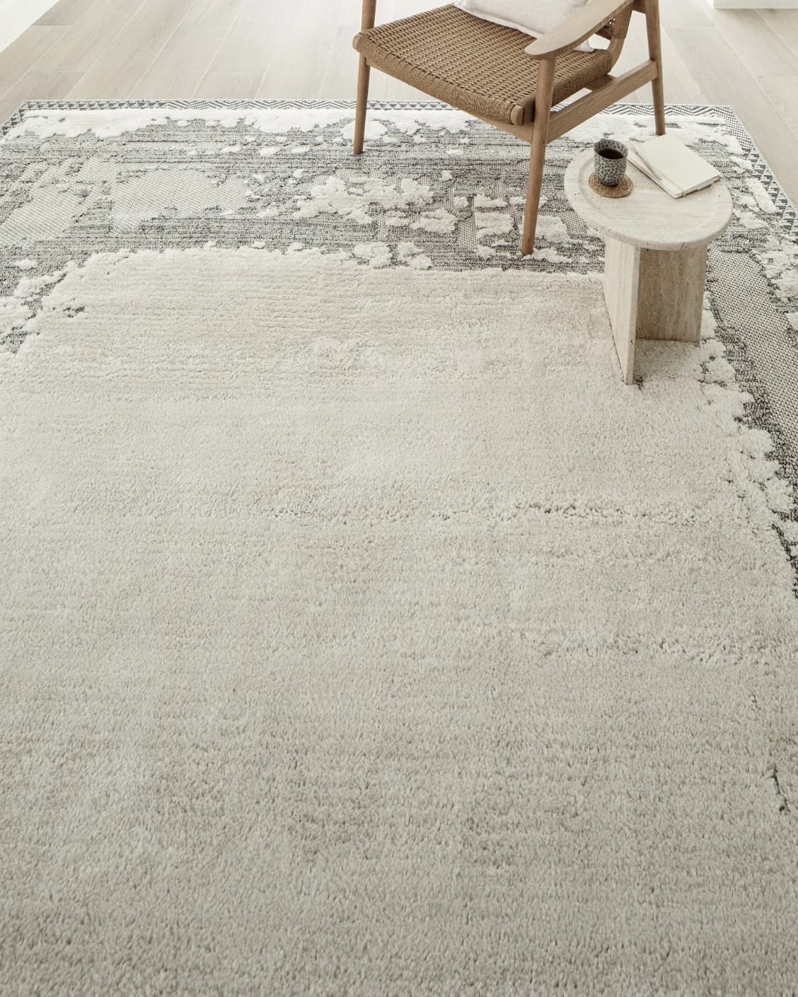 Zahra Bianca carpet in grey and ivory, shown in a lifestyle top view as image 8