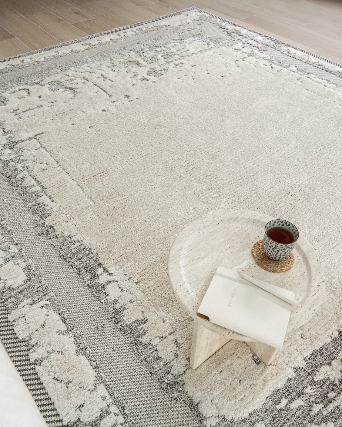 Zahra Bianca carpet in grey and ivory, shown in a lifestyle top view as image 9