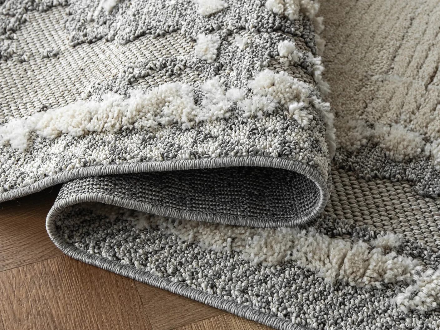 Zahra Bianca Runners carpets in grey and ivory, shown in a product close-up view