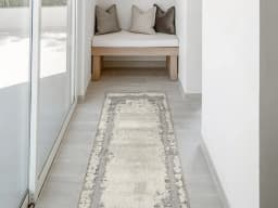 Zahra Bianca Runners carpet in grey and ivory, shown in a lifestyle front view