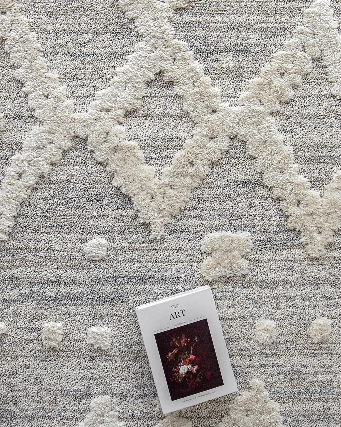 Zahra Snow carpet in grey and off white, shown in a lifestyle top view as image 9