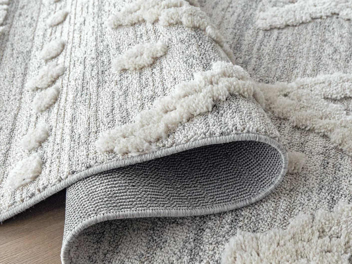 Zahra Snow carpets in grey and off white, shown in a product close-up view