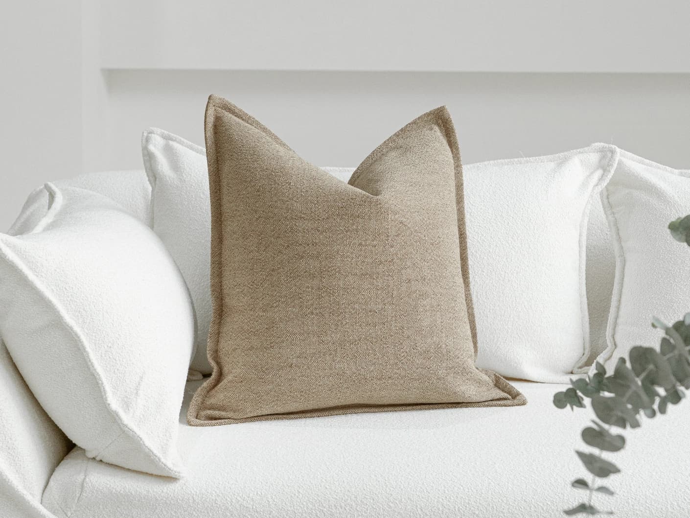 Zane Braun single cushions in beige, shown in a lifestyle front view