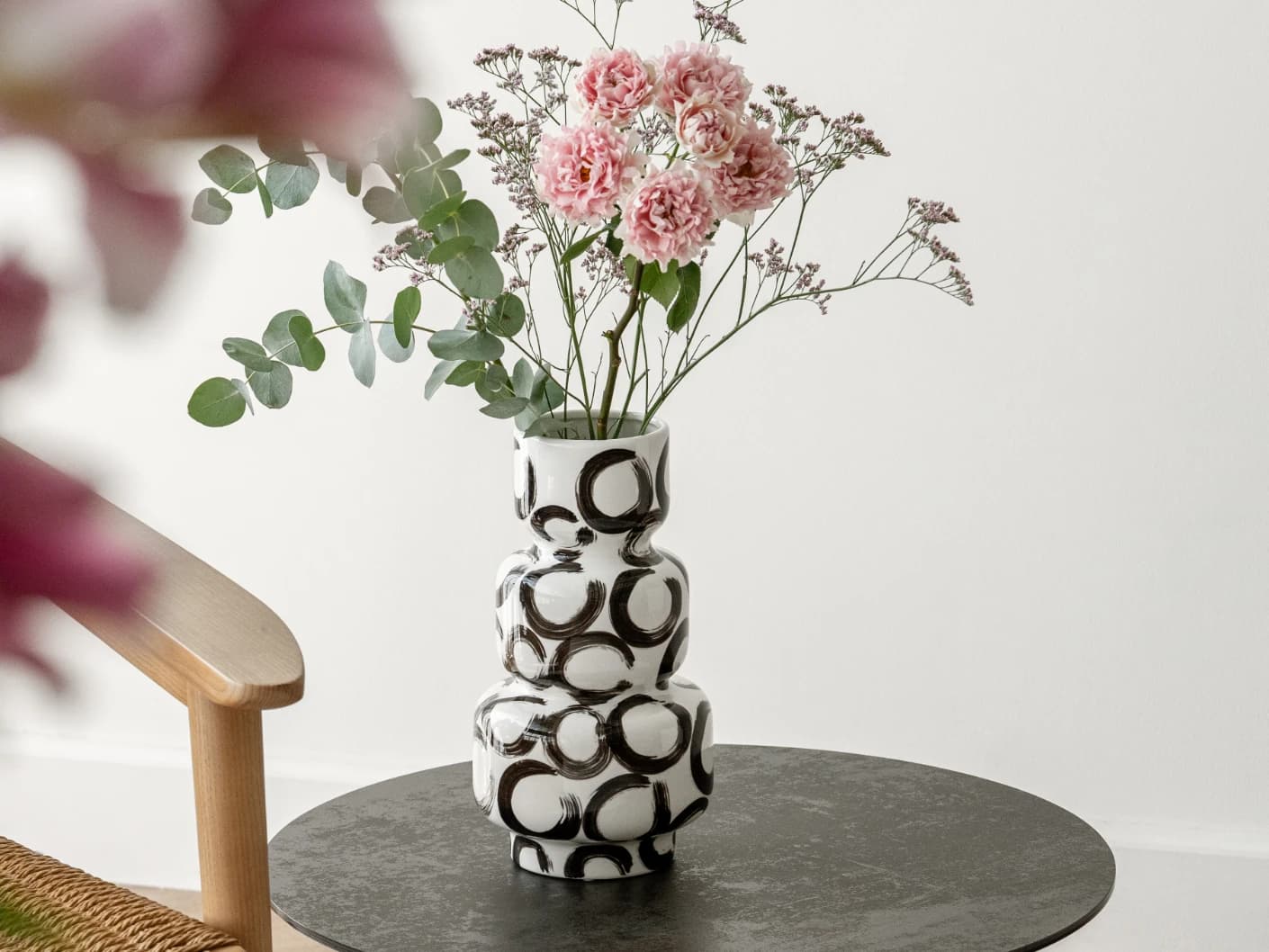 Zara Arneson vases in white and black, shown in a lifestyle front view