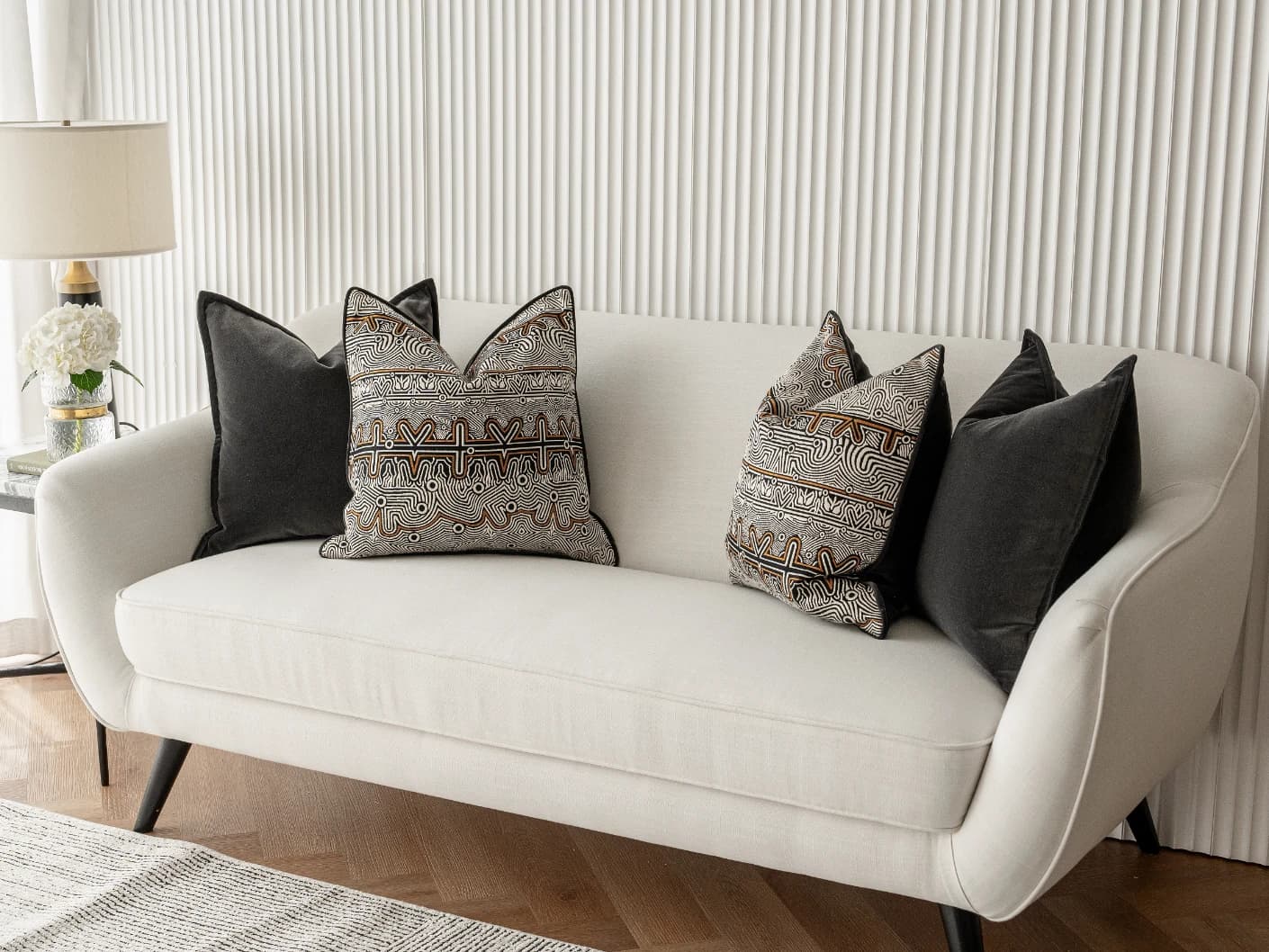 Zayn Bundle bundle cushions in black, grey and silver, shown in a lifestyle front view