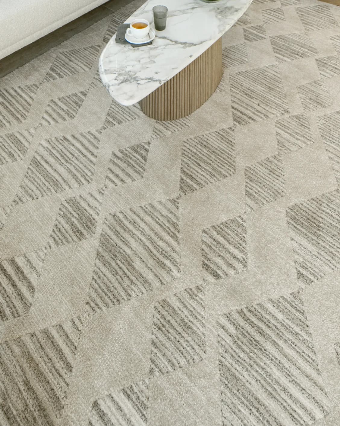 Zen Alba carpet in cream, beige and grey, shown in a lifestyle top view as image 9