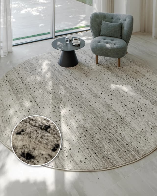 Zen Ashton Round carpet in beige, shown in a lifestyle top view